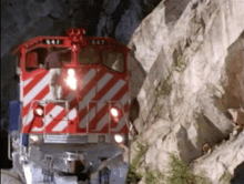 a red white and blue train with the number 647 on the front