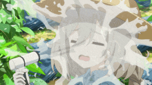 a girl in a hat is being sprayed with water from a hose
