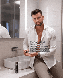 a man in a white shirt is sitting in a bathroom