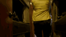 a man with purple hair is walking down a hallway