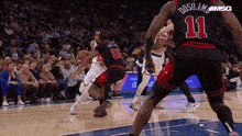 a basketball player with the number 11 on his back is playing basketball