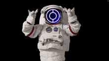 a man in an astronaut 's suit is making a rock and roll sign with his hands .