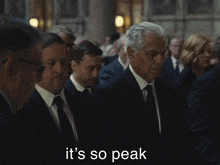 a group of men are standing in a line with the words it 's so peak behind them