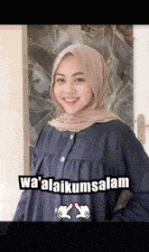 a woman wearing a hijab is standing in front of a door with the words wa ' alaikumsalam written on it