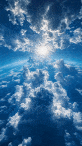 a blue sky with white clouds and the sun shining through