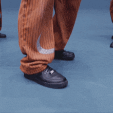 a group of young men are dancing together and one of them is wearing a ring