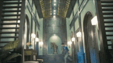 a man is walking down a hallway with a horse statue on the wall