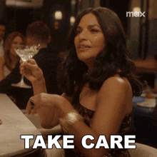a woman sitting at a bar holding a martini glass with the words take care written on the bottom