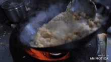 a pan of food is being cooked on a stove and the words made in animotica are visible