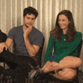 a man and a woman are sitting next to each other on a chair