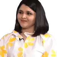 a woman wearing a white shirt with yellow flowers on it