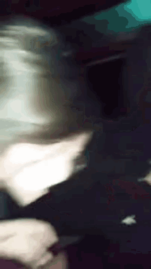a blurry picture of a person 's face with a dark background