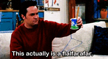 a man sitting on a couch holding a cup that says " this actually is a flalfarafar "