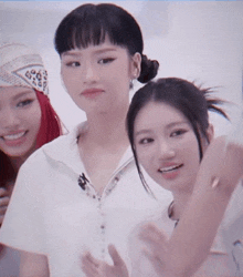 three women are posing for a picture and one of them is wearing a bandana