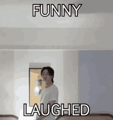 a man is standing in a room with two beds and a sign that says `` funny laughed '' above him .