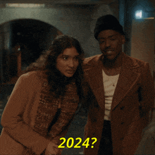 a man and a woman standing next to each other with 2024 written in yellow letters