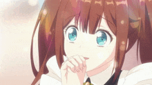 a close up of a girl 's face with blue eyes and brown hair