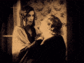 a black and white photo of two women in a room