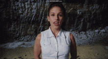 a woman in a white shirt is standing in front of a screen that says www.bandicam.com on it