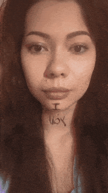 a woman has the word ugly painted on her face