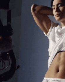 a man wearing a white calvin klein shirt and underwear