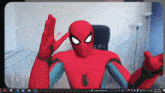 a computer screen shows a spider-man giving a peace sign