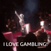 a skeleton is standing on a stage with the words " i love gambling " written below him