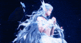 a woman with long white hair is standing in the water