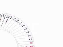 a stack of playing cards on a white surface