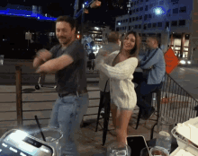 a man and woman are dancing in front of a sign that says special event head