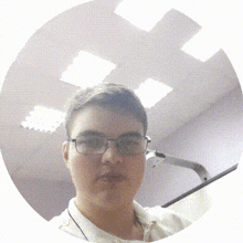 a young man wearing glasses and a white shirt is standing in a circle