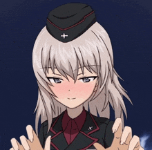 a girl with a hat and a cross on her head is touching someone 's hands .