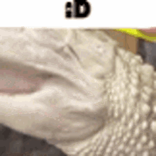 a close up of a person 's face with a yellow ribbon around their neck .