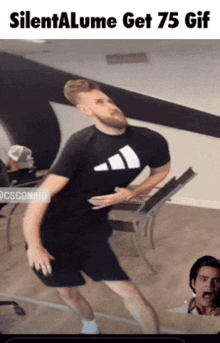 a man in an adidas shirt is dancing in a gym