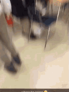 a blurry picture of people walking in a classroom with a smiley face on the bottom