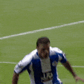 a soccer player wearing a blue and white jersey with the number 9 on the front