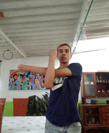 a young man wearing a blue nike shirt is stretching his arms