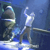 a man is dancing in front of a monster that says daddy fed me .