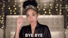 a woman in a black robe says bye bye in white letters