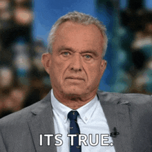 a man in a suit and tie is saying " it 's true "