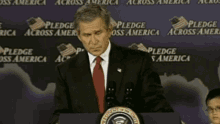 a man in a suit and tie stands at a podium with the words " fool me once " on the bottom