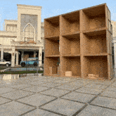 a blue car is parked in front of a building that says ' dubai ' on it