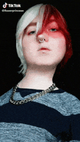 a girl with red and white hair and a nose ring .