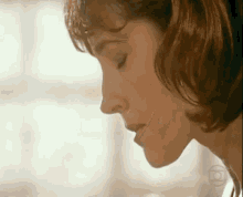 a close up of a woman 's face with her eyes closed .