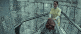 a woman in a yellow uniform is pushing a person up an escalator
