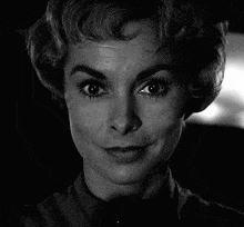 a close up of a woman 's face with a black background