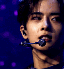 a close up of a person 's face with a microphone in it