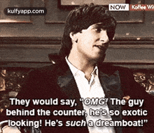 a man in a tuxedo is sitting on a couch and talking .