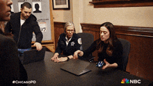 a group of people sitting around a table with nbc written on the bottom right