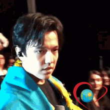 a man in a blue jacket stands in front of a microphone